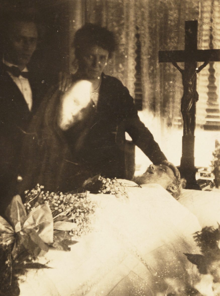#16 A man’s face appears over a funeral scene.