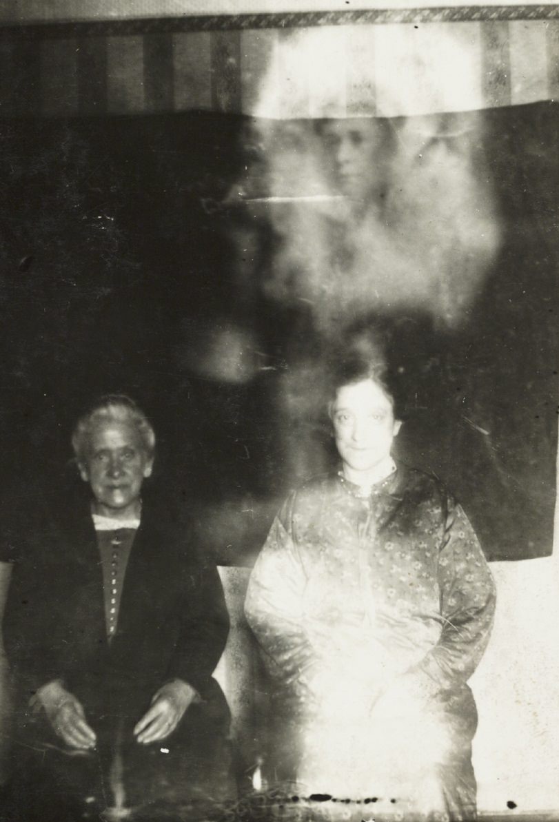 #18 A woman’s face appears above two women.