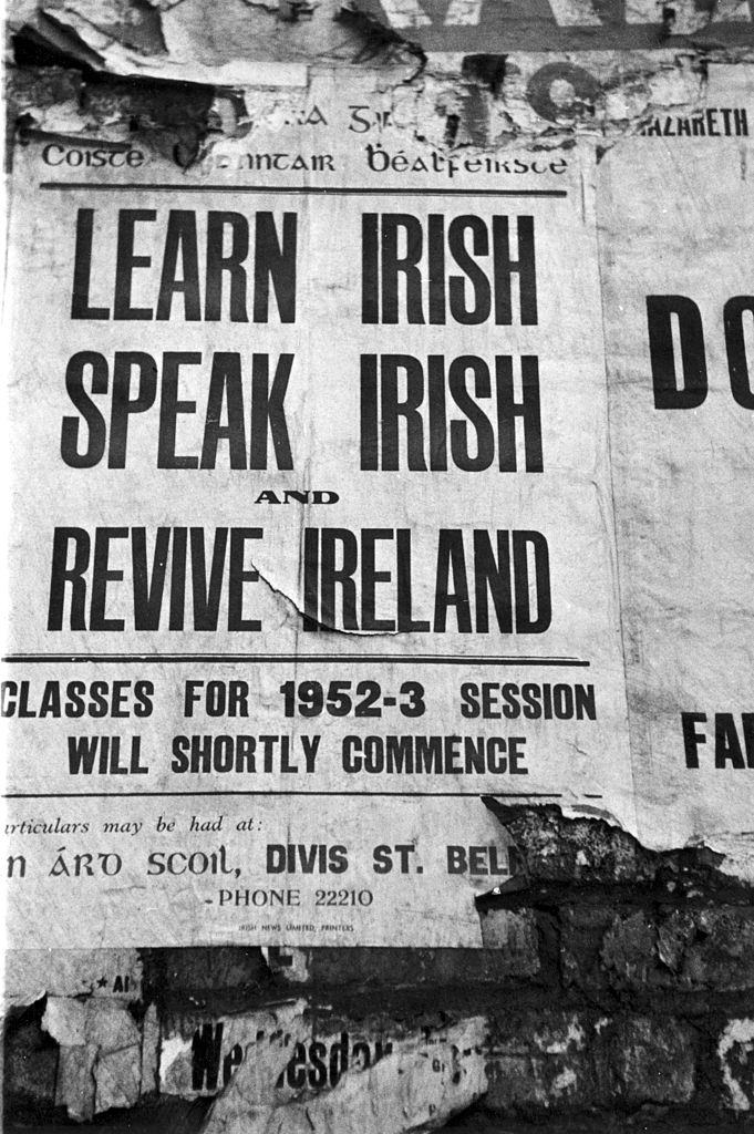 #8 A poster advertising lessons in the Irish language on a wall in Belfast, 1954.