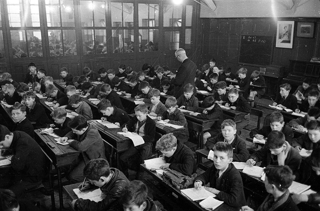 #34 A crowded classroom where 248 children are taught at once in a Belfast school, 1954.