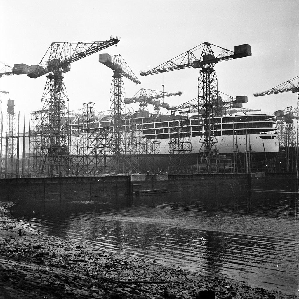 #36 Cranes in Belfast shipbuilding yard surrounding a nearly finished ship, 1954.
