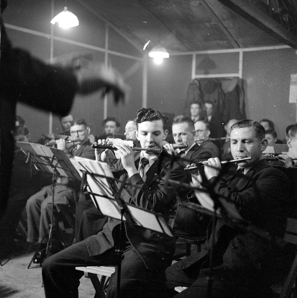#38 Men employed as shipyard or factory workers playing in a flute band in Belfast, 1954.