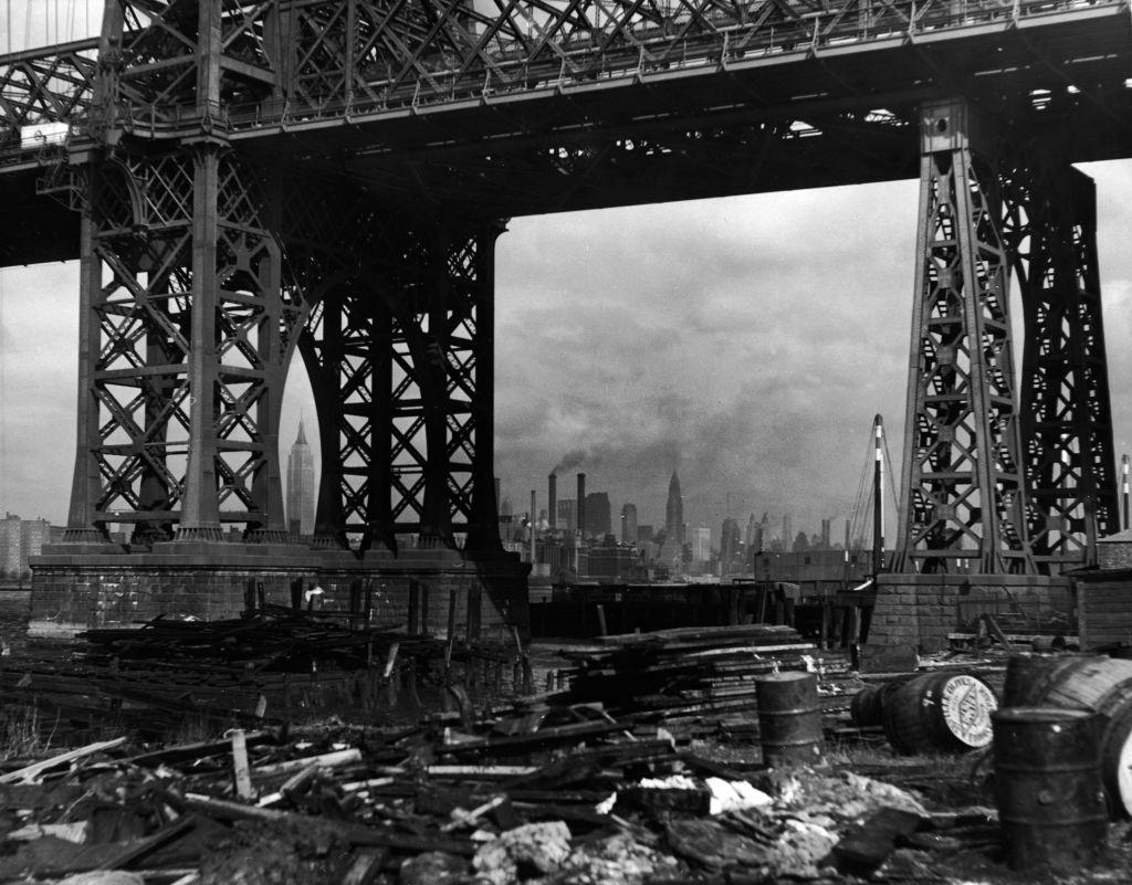 #20 Williamsburg Bridge and the Manhattan skyline taken from under the bridge on the Brooklyn side, New York City, 1950.