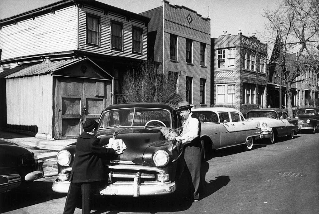#24 An Italian-American man and his son washing their car in Brooklyn, New York City, 1956.
