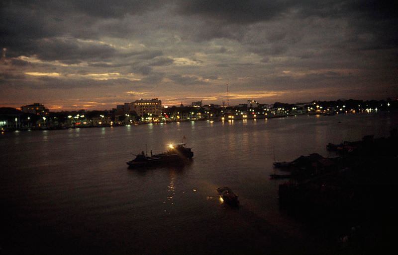 #17 A nighttime patrol boat shines a searchlight on a sampan in Saigon, 1965