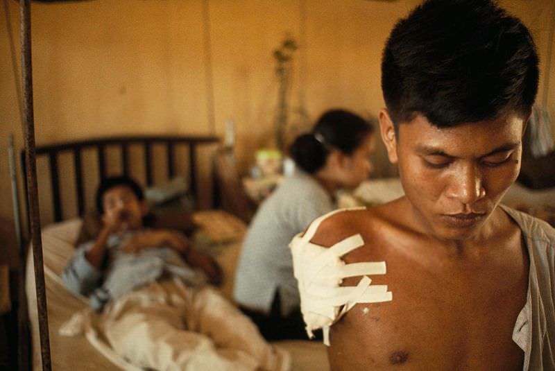#11 A soldier suffers after losing an arm in a battle west of Saigon in Saigon, 1965
