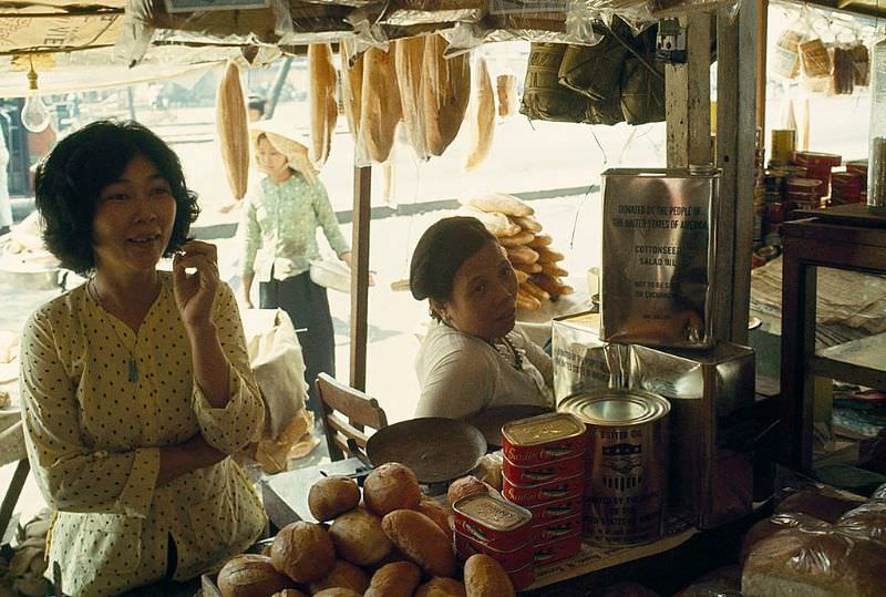 #19 A vendor sells canned goods sent as gifts to the Vietnamese people in Saigon, 1965