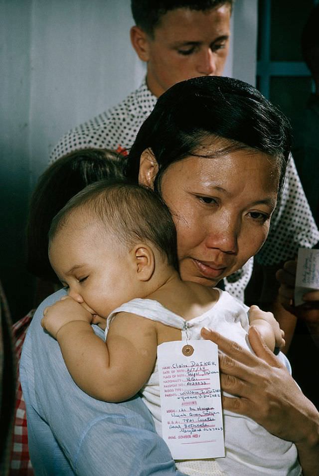 #20 A Vietnamese nurse hugs her American ward before saying goodbye in Saigon, 1965