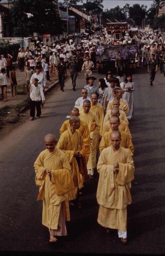 #45 Monks walking on the street during the deposing of President Ngo Dinh Diem in Saigon, 1963.