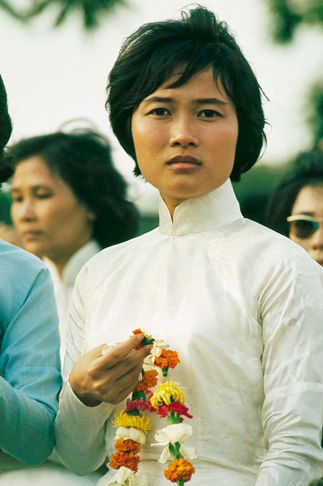 #13 A greeter of the Women’s Army Forces waits for Korean troops in Saigon, 1965