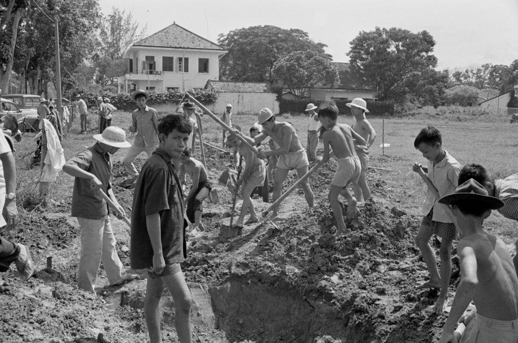 #55 Men and boys digging in Saigon, 1964.