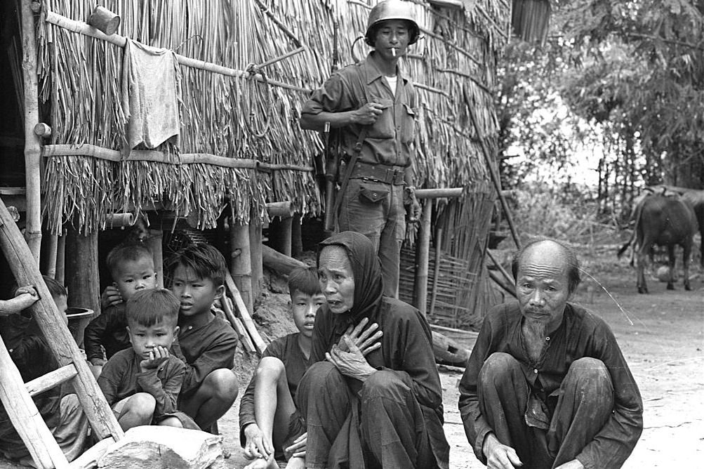 #60 Vietnamese Army personnel interrogate villagers during a drive against the Viet Cong, 1965.