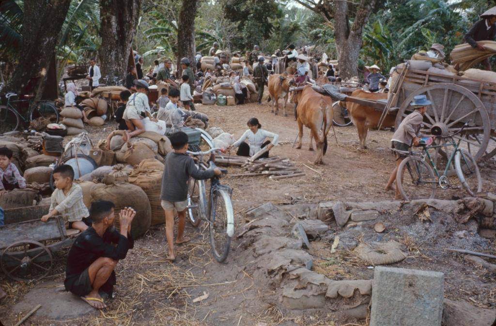 #66 View of civilians and their belongings as they wait to evacute, as part of Operation Cedar Falls, from the Iron Triangle village of Ben Suc, Vietnam, 1967.