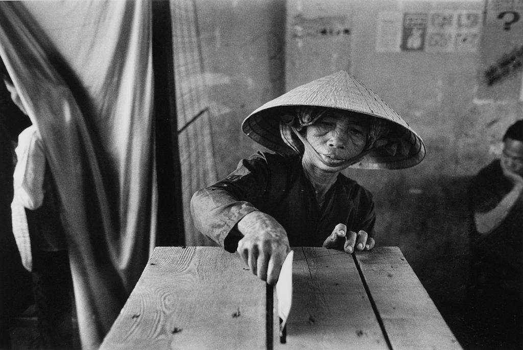 #67 A woman putting voting-paper into the ballot-box in elections, 1969.