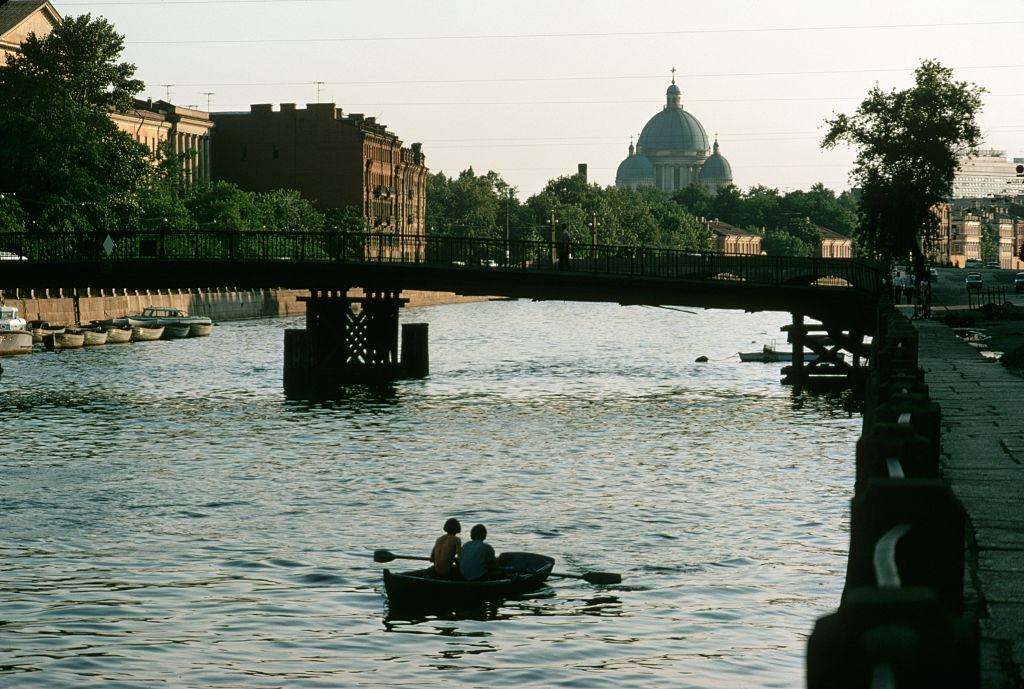 #12 A rowboat passes beneath a bridge over one of Leningrad’s many canals, 1972.