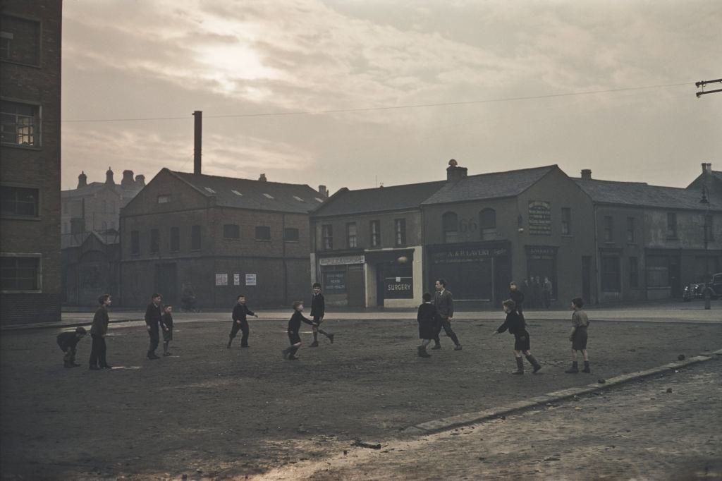 #14 A group of boys playing football in a Belfast street, 1955.