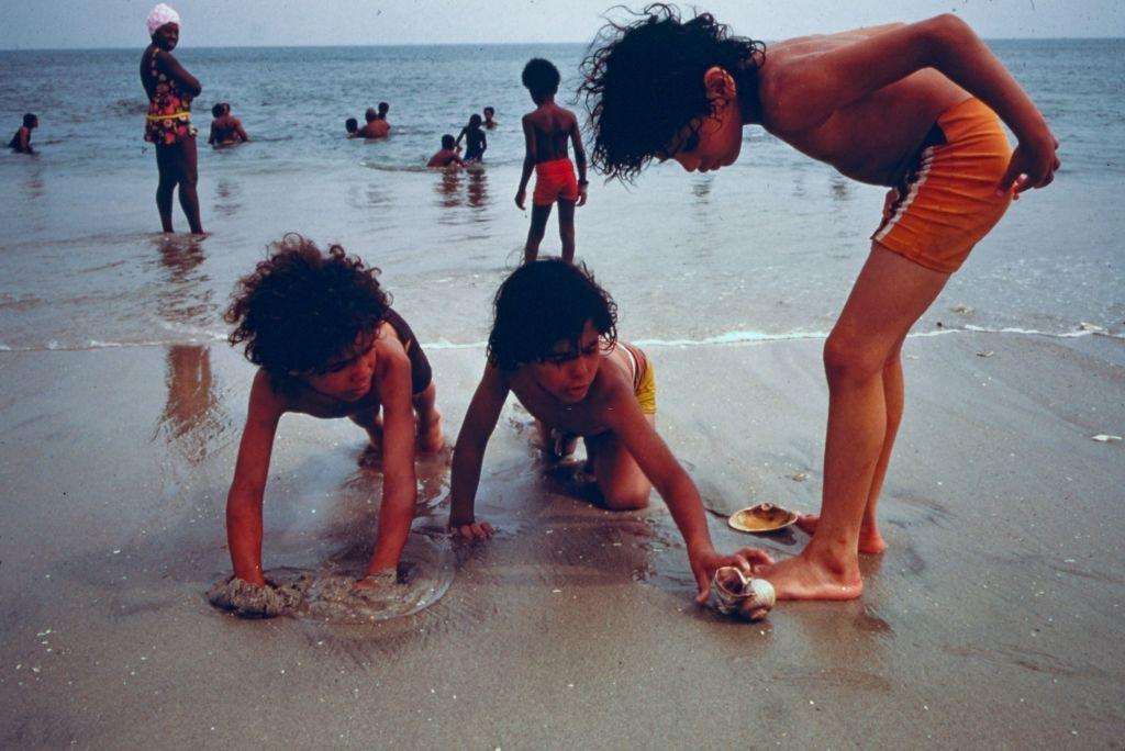 #51 Children playing on the shore at Reis Park, a public beach in Brooklyn, New York City, 1974.