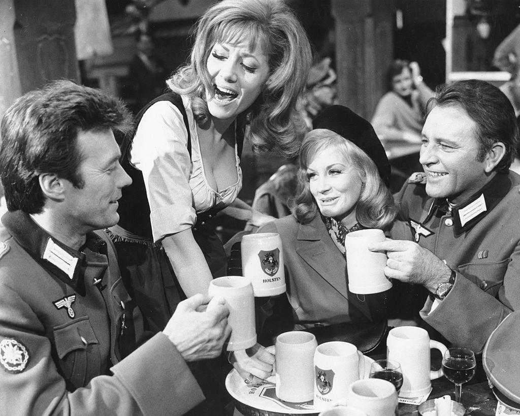 #54 Clint Eastwood with Ingrid Pitt, Mary Ure, and Richard Burton, in a scene from ‘Where Eagles Dare’, 1967.
