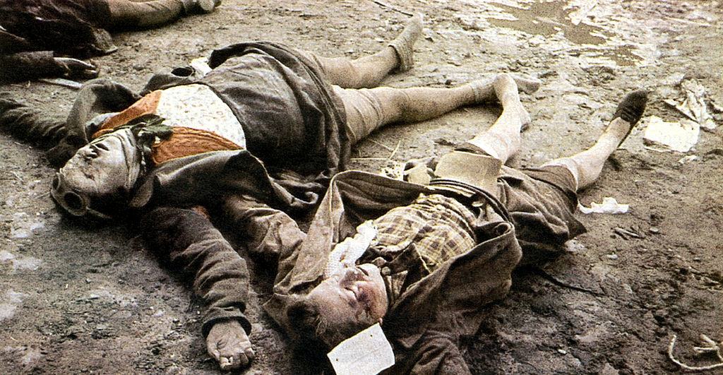 The bodies of two girls are laid out on the pavement. 25th February 1945.