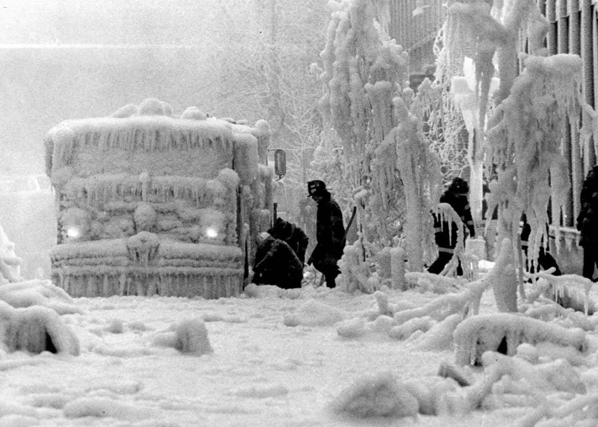 #16 Firemen try to free equipment encrusted in ice after their fight with a five-alarm fire in a vacant hotel in Brooklyn.