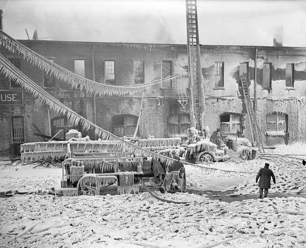 #19 The sudden return of near-zero weather worked a hardship on firemen fighting a blaze at 33rd Street and Eleventh Ave., New York, 1936.