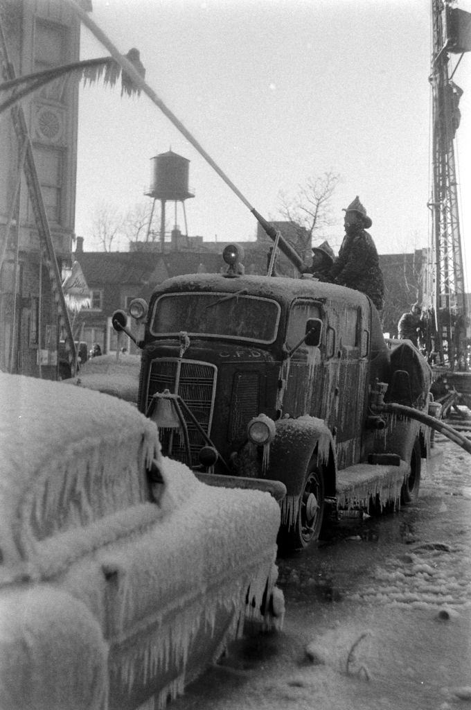 #27 Firefighters spraying water during winter in Chicago, Illinois, 1958