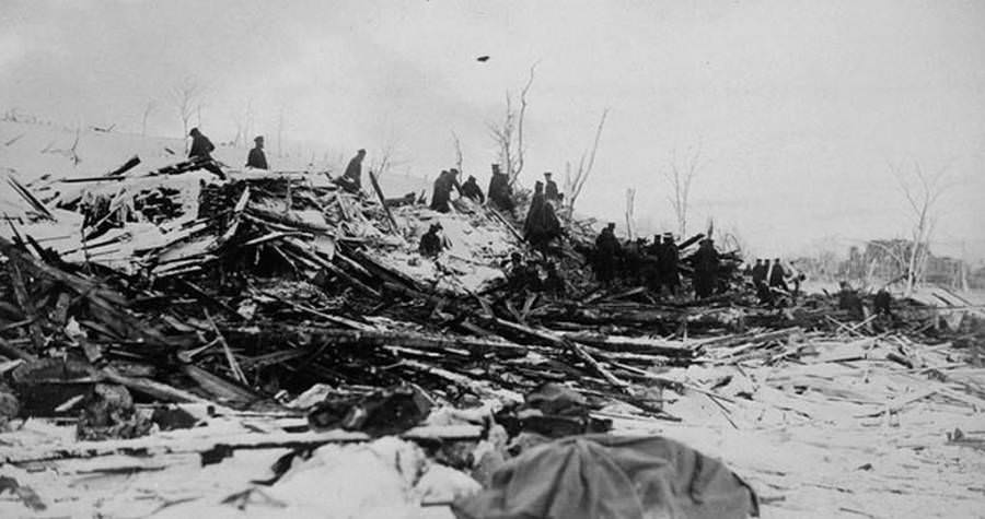 Workers sift through the ruins of peoples’ homes.