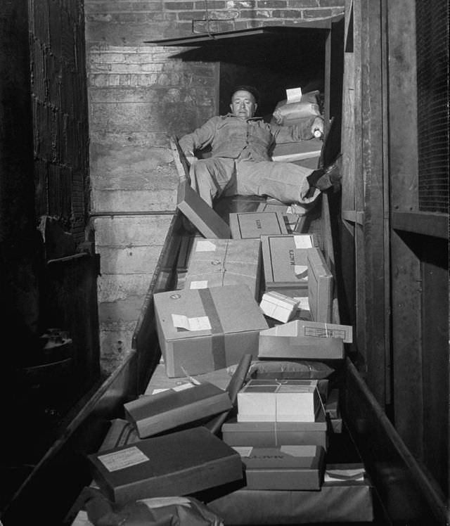 #2 An employee clearing the package chute with his body.
