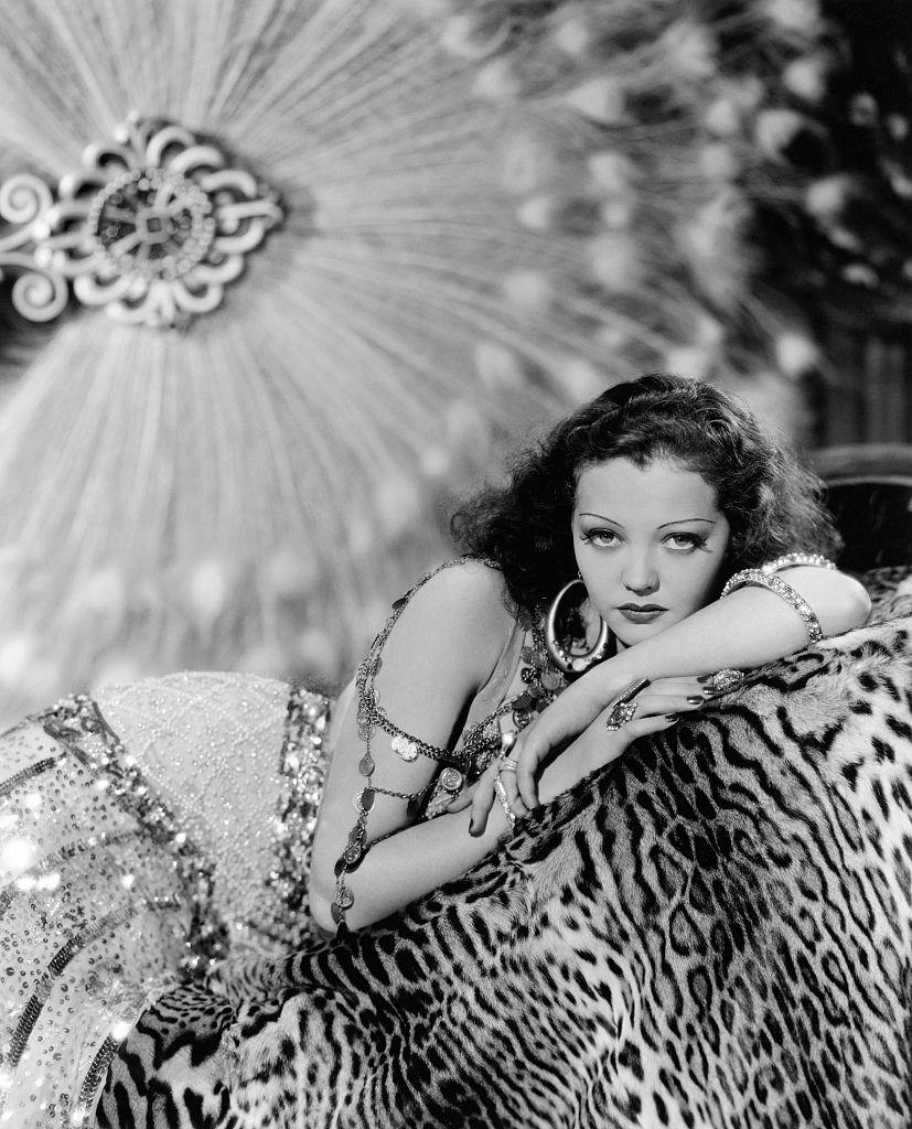#32 Sylvia Sidney reclines on a leopard skin, dressed for the role of Lillie Taylor in the 1934 film ‘Good Dame’.