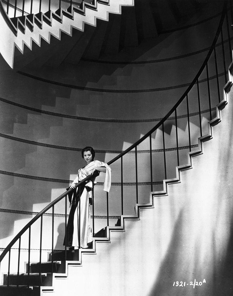 #48 Sylvia Sidney standing on a spiral staircase, 1935.