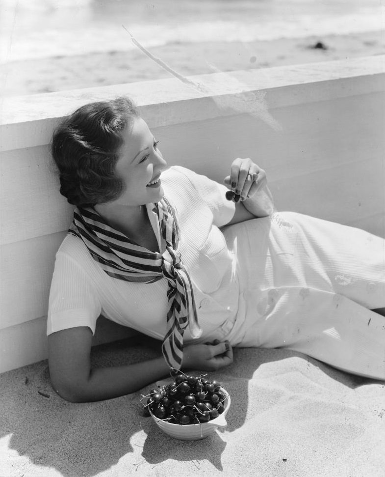 #62 Sylvia Sidney, eating a bowl of fresh cherries, 1935.
