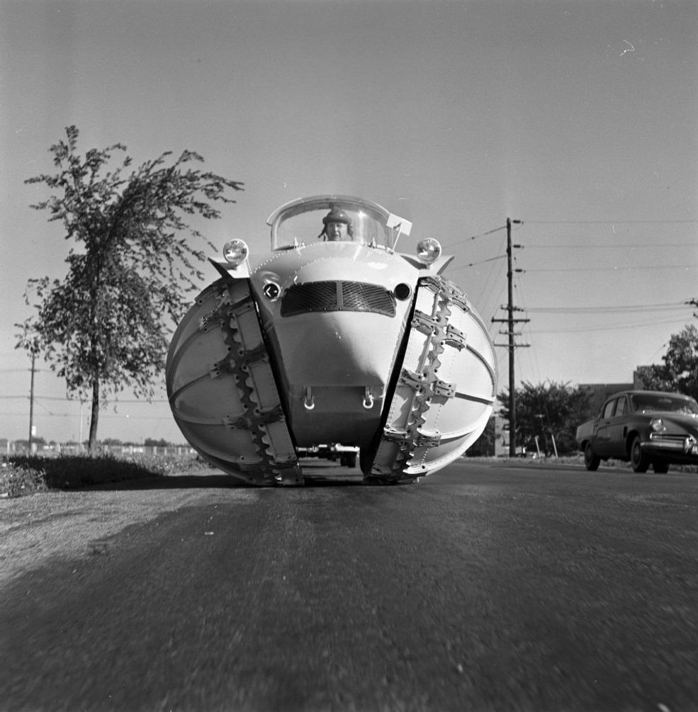 Man driving four-wheel vehicle ‘Rhino’ with hemispheric wheels.