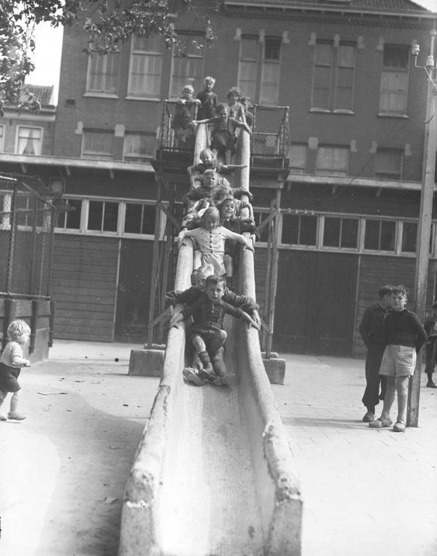 #7 Children on a (hard granite) slide. Amsterdam, 1946