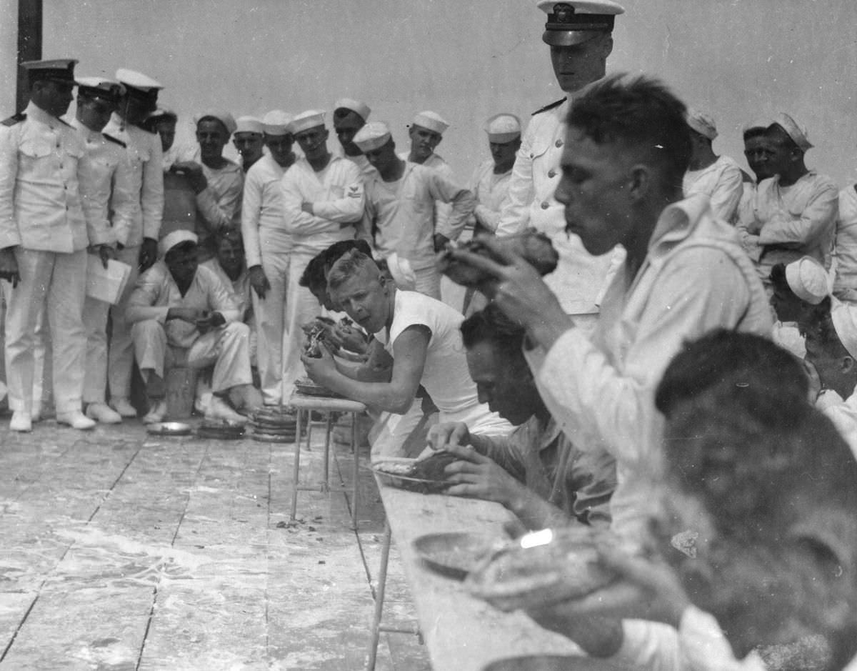 Men tuck into a row of pies during a contest on a Navy Ship in 1922.