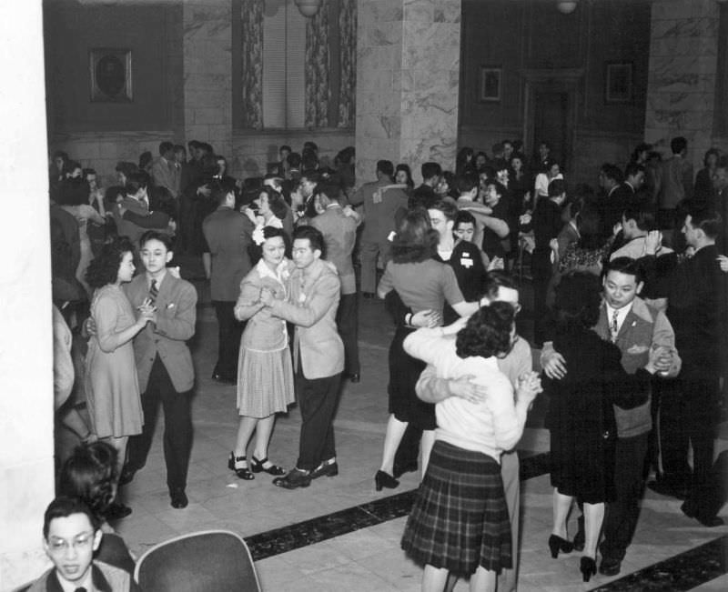 #9 Happy Nisei and Caucasian couples throng the dance floor of the YMCA at the All-American Fun Night program in Chicago this winter, 1944.