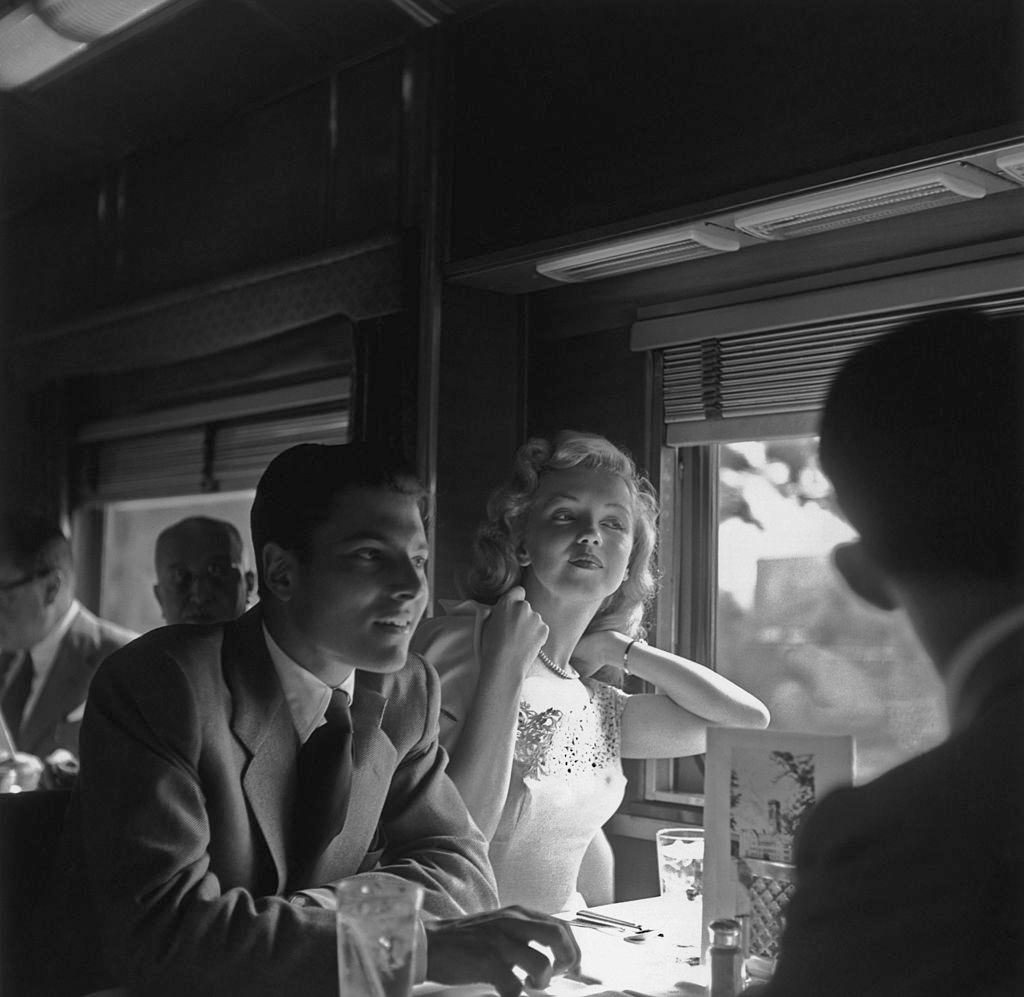 Marilyn Monroe with actor Lon McAllister riding on a train for the promotion of movie ‘Love Happy’, 1949.