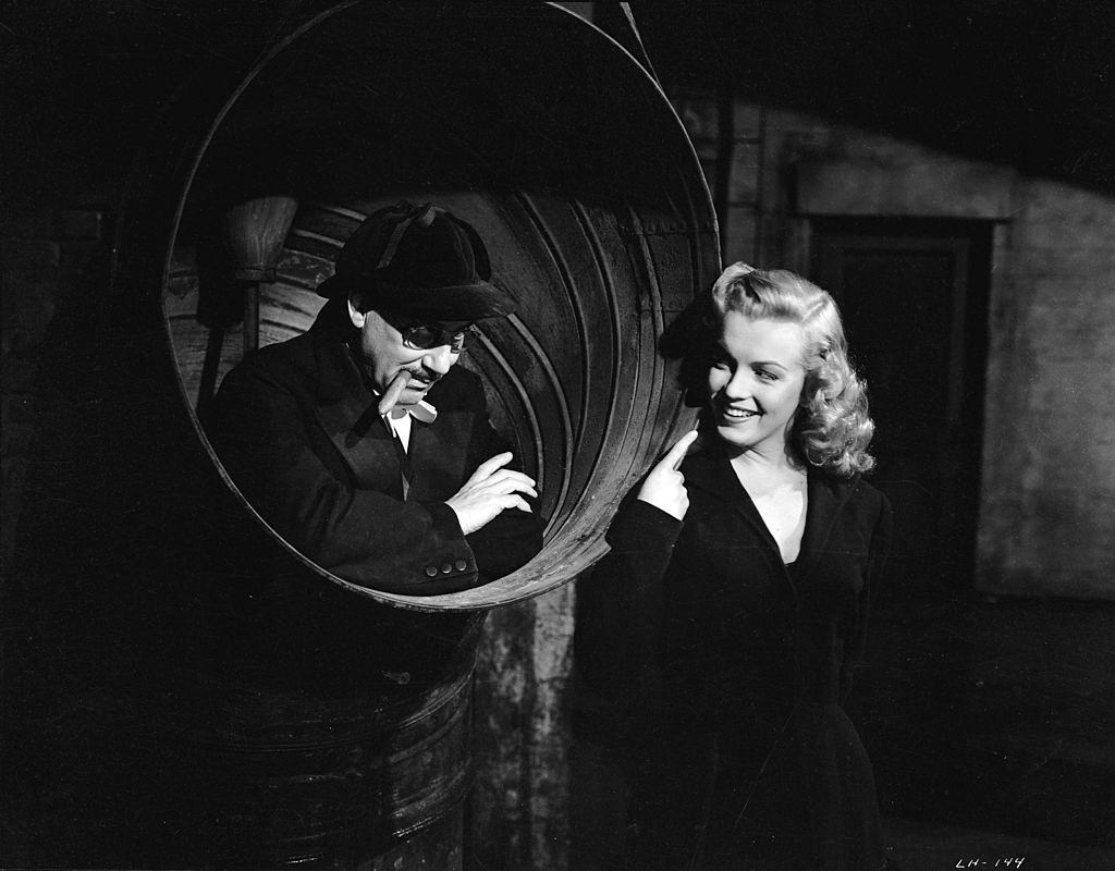 Marilyn Monroe finds Groucho Marx hiding in a ship’s funnel in the crime caper ‘Love Happy’, 1949.