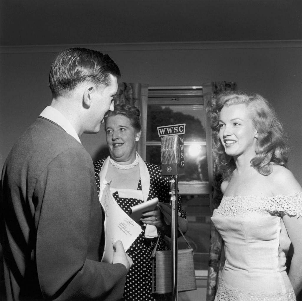 Marilyn Monroe with a man and woman during her movie proomotion, 1949.