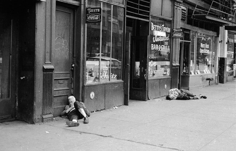 Two drunks asleep on the street outside Betty’s Tavern in New York.