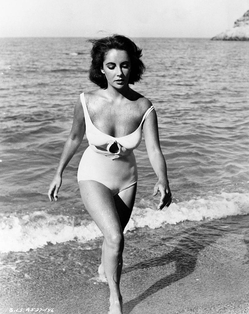 Elizabeth Taylor is shown walking onto the beach from the water in a scene from “Suddenly Last Summer.”