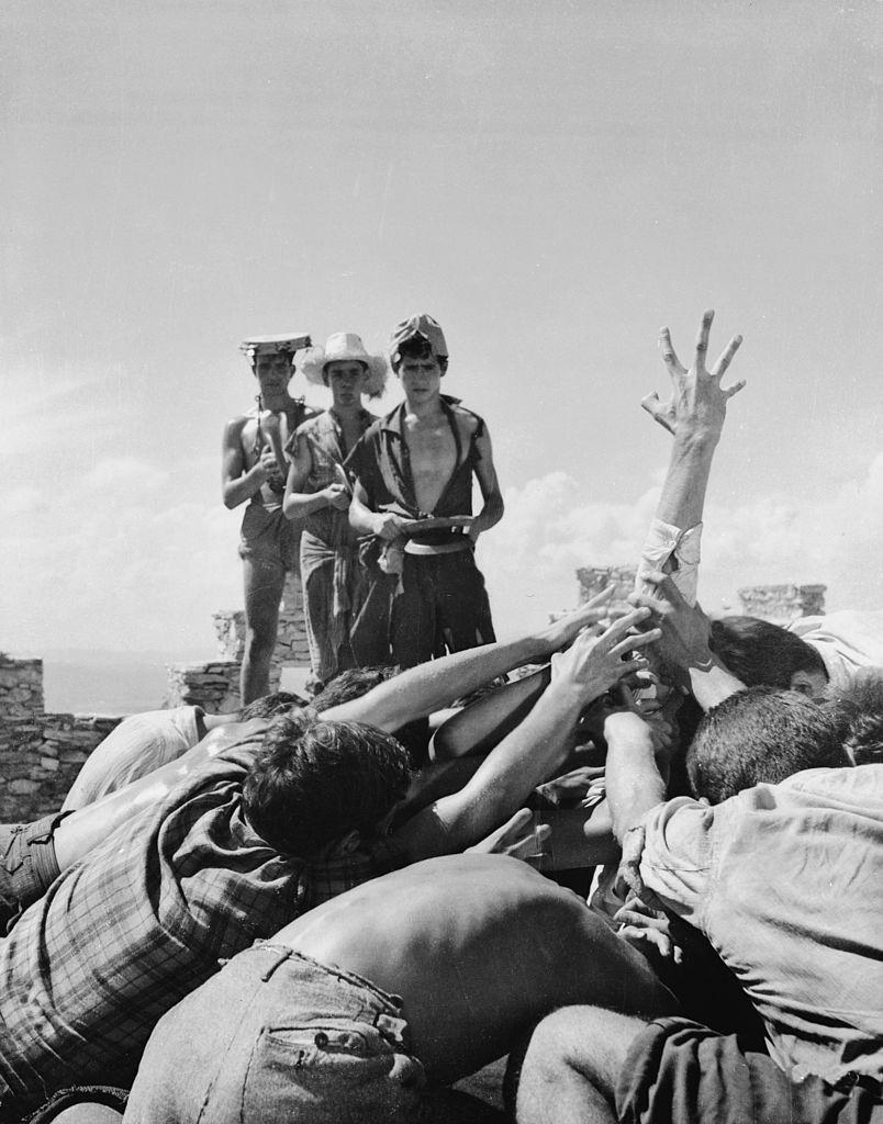 The unfortunate Sebastian disappears amidst a horde of cannibalistic street urchins in a scene from ‘Suddenly Last Summer’, 1959.