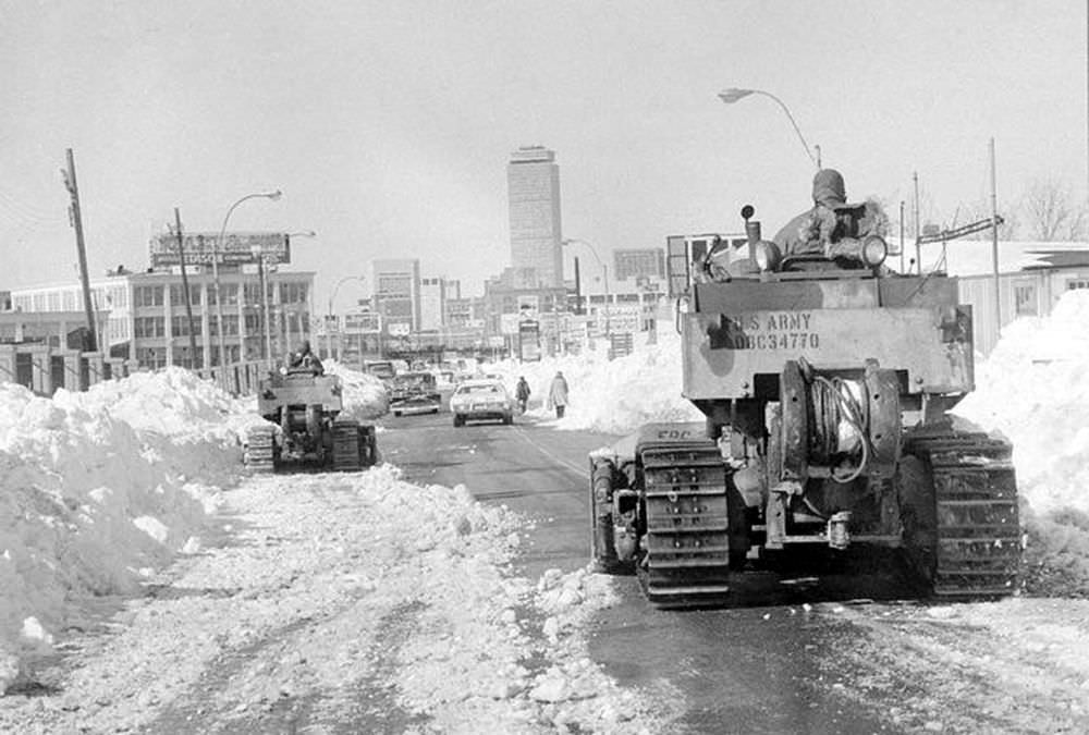 #14 Two members of the U.S. Army 27th Engineers from Fort Bragg, N.C. move their bulldozers slowly toward downtown Boston as the city began to remove the record snowfall from the streets, Feb. 11, 1978.