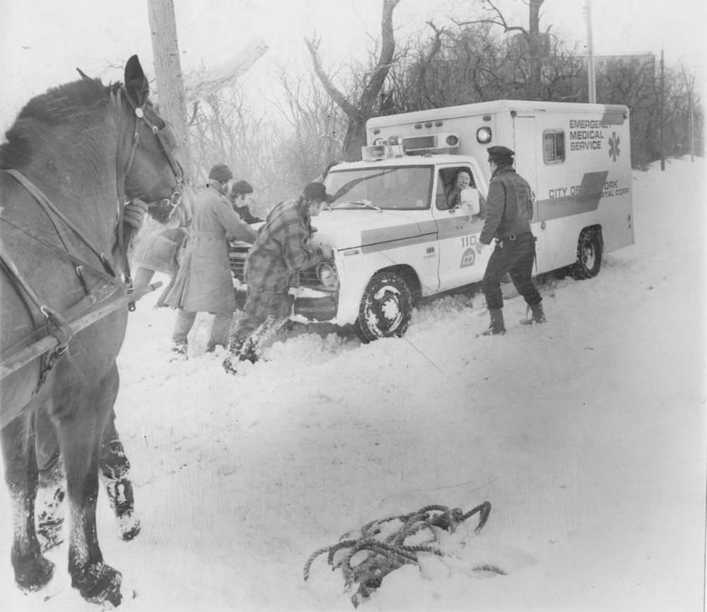 #16 Men struggle to free an ambulance carrying a heart patient that is stuck on Bard Ave., West Brighton.