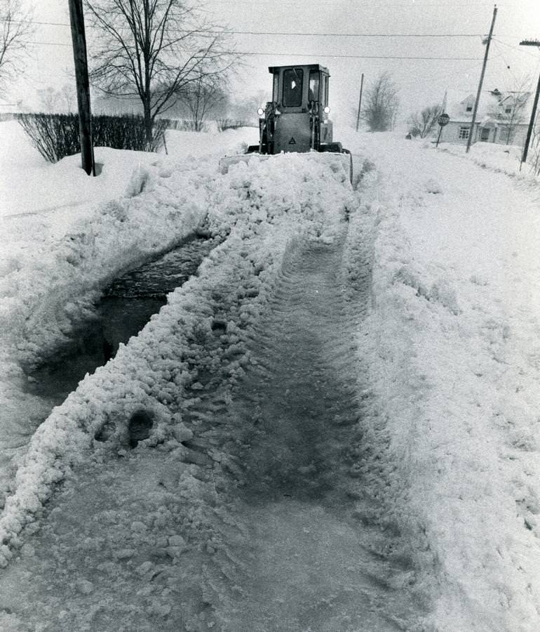#45 A front-end loader digs through snow Jan. 27, 1978, on Eastern Road in Rittman.