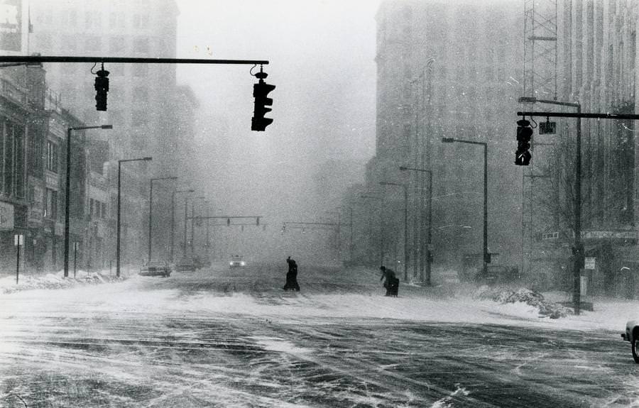 #48 Pedestrians struggle to cross an Akron road during the blizzard on Jan. 26, 1978.