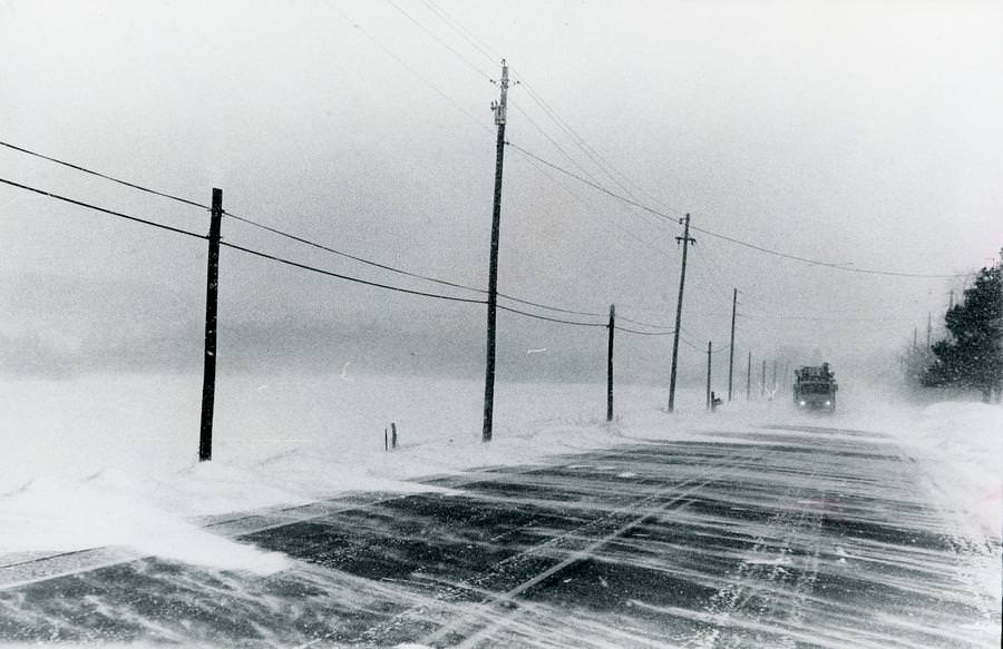 #52 Ohio Edison trucks could barely be seen on state Route 82 east of Mantua Corners in this Jan. 27, 1978.