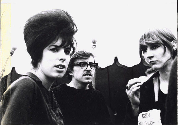 #46 Girl eating crisps with couple