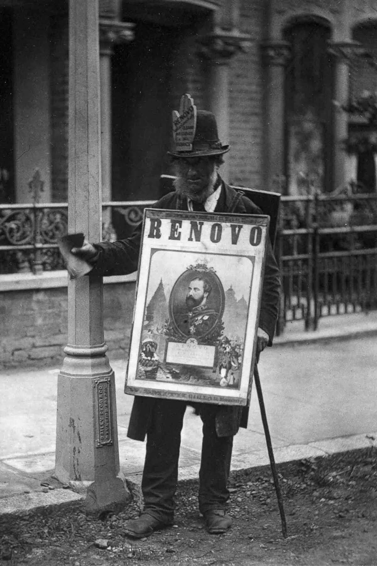 #12 A man wears a sandwich-board advertisement, 1877.