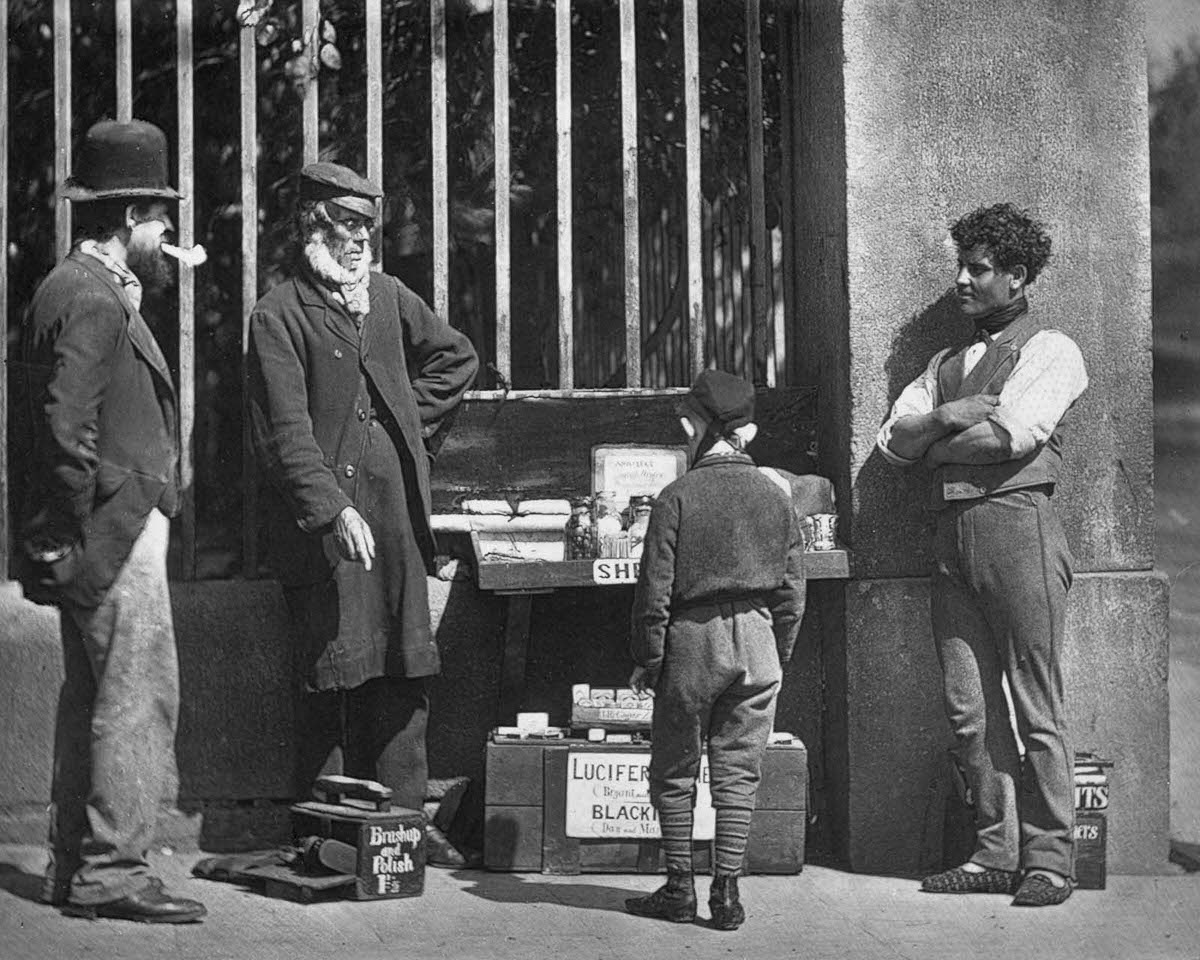 #21 A street trader and shoeshine, 1877.