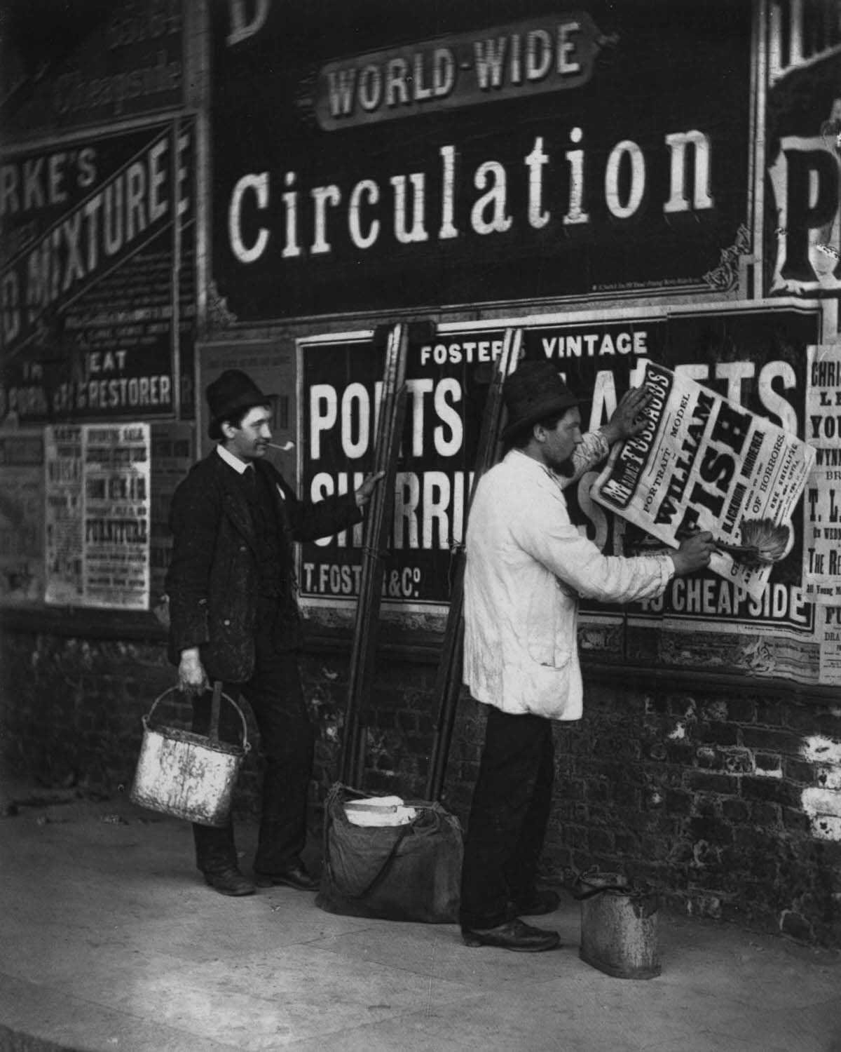 #6 Bill stickers paste placards advertising Madame Tussaud’s waxworks museum, 1877.